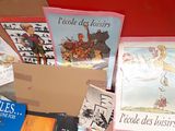 many books in a box sitting on the floor