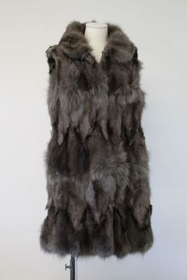 a picture of a fur vest on a mannequin stand