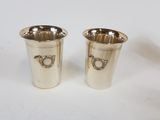 pair of silver plated cups with handles on each side
