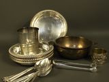 an assortment of silverware including a bowl, spoon, and spoon rest
