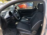 the interior of a small car with two seats and a steering wheel