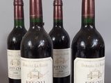 six bottles of wine are lined up on a table