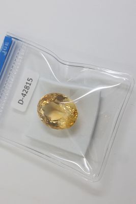 un gros plan d'un diamant jaune dans un sachet en plastique transparent