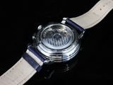 a close up of a watch on a black surface