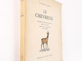 an old book with a picture of a deer on it ' s cover