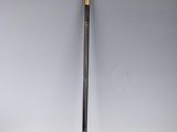 a black and gold cane sitting on top of a white table