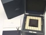 a box with a watch inside of it on a table