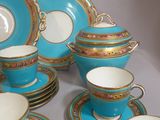a blue and gold tea set on a table