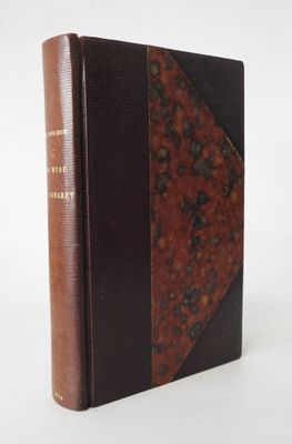 a brown and black book sitting on top of a white table