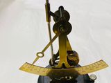 a brass scale with a ruler on it on a table
