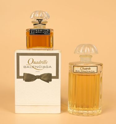 an image of a bottle of perfume next to a box