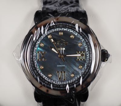 a close up of a watch on a white surface
