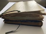 une pile de livres posée sur une table, sur laquelle se trouvent une paire de lunettes