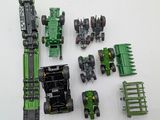 a green toy tractor and other toy vehicles on a white surface