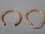 pair of gold plated hoop earrings on a white surface