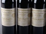 four bottles of wine are lined up on a table