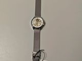 an image of a wrist watch sitting on top of a table