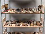 a wooden shelf with rocks and other rocks on top of it
