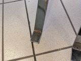 a glass table with a mirror top on a tiled floor