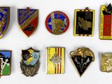 a lot of badges that are on a white surface