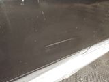 an image of a dirty car door with the handle missing