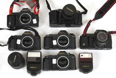 a lot of cameras that are sitting on a table