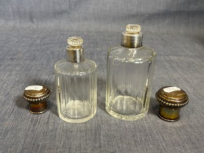 three glass bottles sitting on a table next to each other