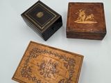 three small wooden boxes sitting on top of a white surface