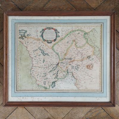 an old map of england in a frame hanging on a wall