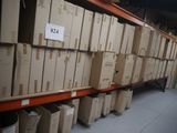 boxes are stacked on a shelf in a warehouse with a price tag on it