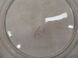 a white plate with red writing on it sitting on a table