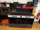 a black and white stove and some shelves in a garage