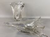 two glass vases sitting on a table with a white background