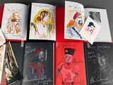 a lot of books with drawings on them on a table