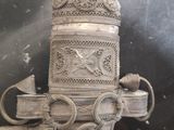 a silver vase that is sitting on top of a table