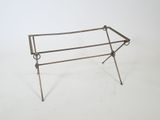 a metal table that has a metal frame on it