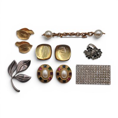 an assortment of jewelry including a broochle, earrings and a bracelet
