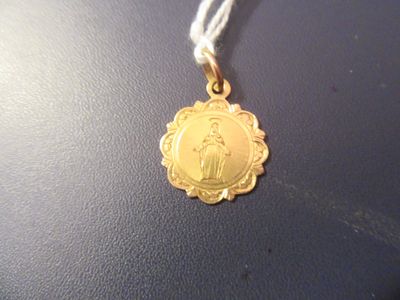une médaille d'or avec la photo d'une femme dessus