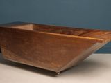an old wooden bath tub sitting on top of a table