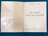 an open book on a blue surface with a white cover