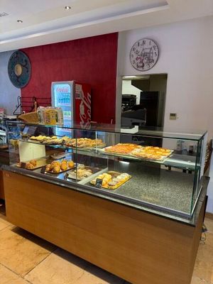 a picture of a bakery counter with a variety of pastries