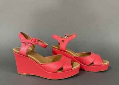pink wedged sandals with buckles on the toes and a platform
