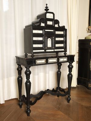 a black and white birdcage sitting on a wooden table