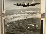 an old black and white photo of a plane flying over a body of water
