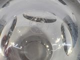 a close up of a glass vase with a reflection of a person in it