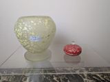 two vases sitting on a glass table with a label on it
