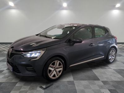 the grey car is parked on a checkered floor in a garage