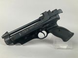 gun on a clear stand on a white surface with a white background