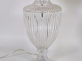 a glass lamp that is on a white table