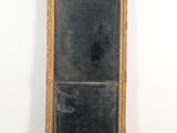 an image of a large gold framed mirror on a white wall
